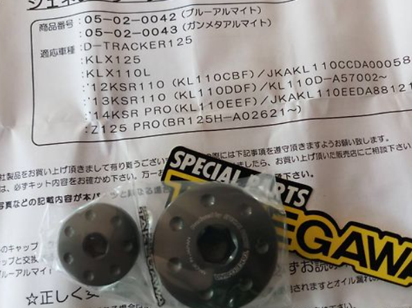 Two black hub caps on a paper packaging with 'SPECIAL PARTS' and 'GAWA' branding.