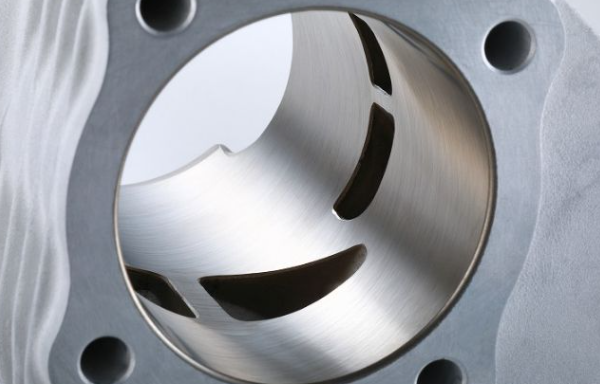Close-up of a metallic engine piston with a detailed view of its surface.
