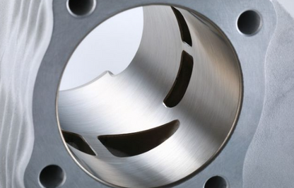 Close-up of a metallic engine piston with a detailed view of its surface.