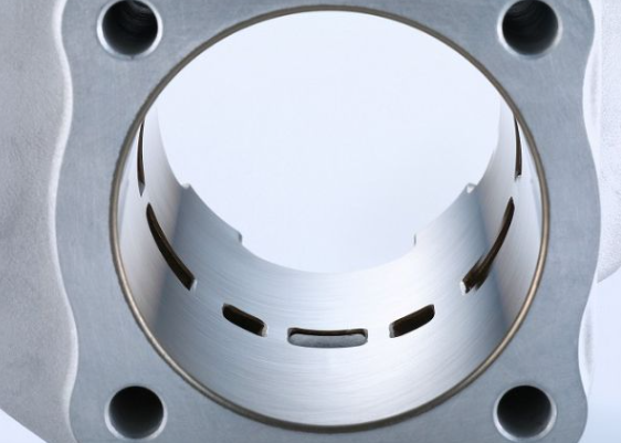 Close-up of a metallic engine piston on a white background