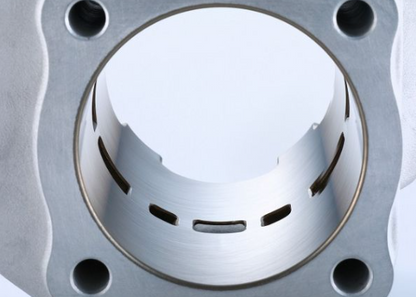 Close-up of a metallic engine piston on a gray background