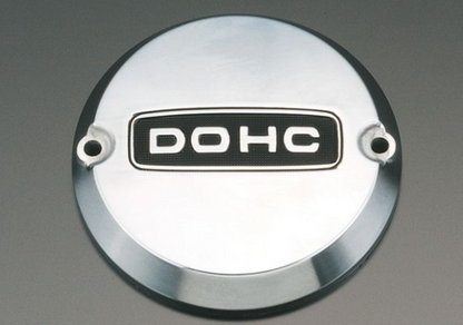 Metallic engine cover with 'DOHC' branding on a gray background
