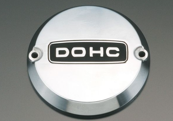 Metallic engine cover with 'DOHC' branding on a gray background
