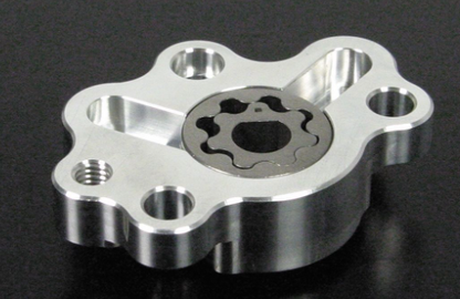 Metallic mechanical component with gear-like design on a black background