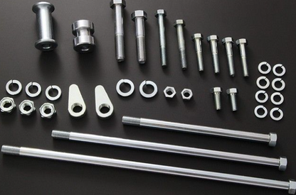 Collection of metal bolts, nuts, and washers on a black background