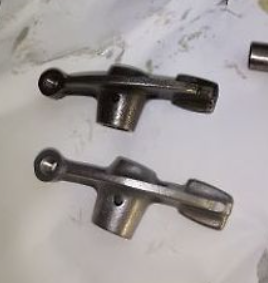 Metal lever and handle components on a white background