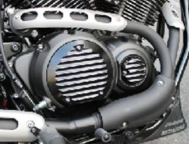 Close-up of a motorcycle engine with a visible brand logo.