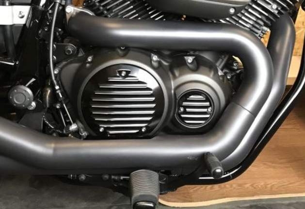 Close-up of a motorcycle engine on a wooden surface
