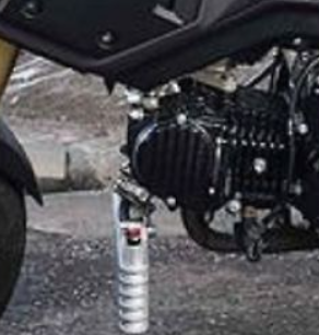Close-up of a motorcycle's suspension system with a blurred background