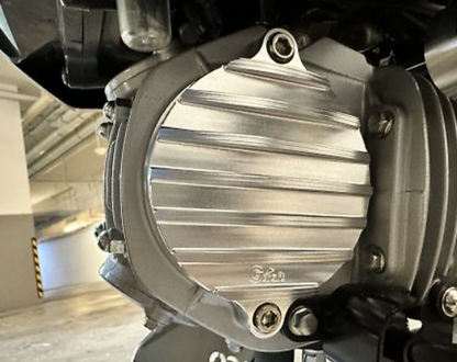 Close-up of a motorcycle engine cover with 'Suzuki' branding.