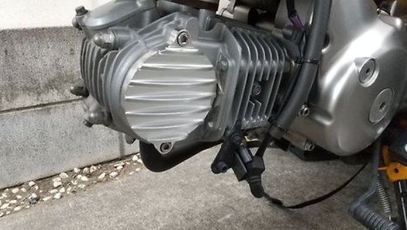 Close-up of a motorcycle engine on a concrete surface