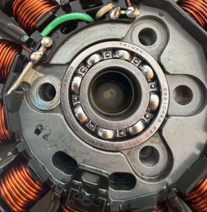 Close-up of a mechanical component with copper coils and bearings