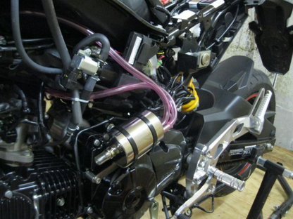 Close-up of a motorcycle engine with visible wiring and components.