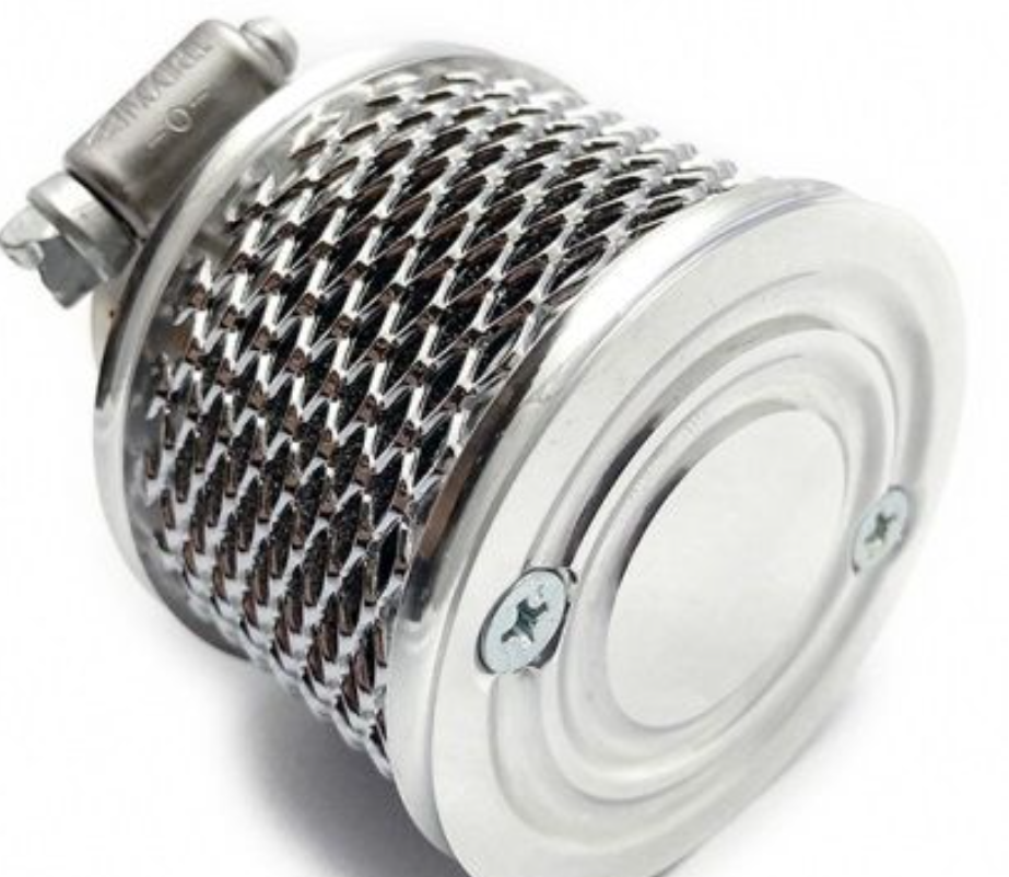 Close-up of a metallic and white cylindrical object with a grid pattern on a white background