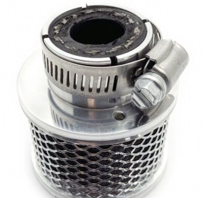 Metallic filter or exhaust component on a white background