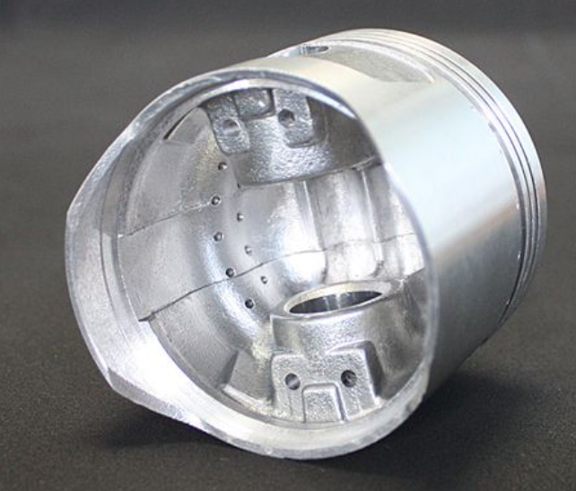 Metallic cylindrical component on a dark background