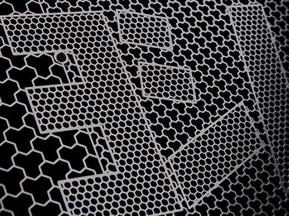 Close-up of a metallic honeycomb pattern on a black background
