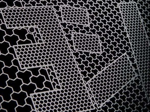 Close-up of a metallic honeycomb pattern on a black background