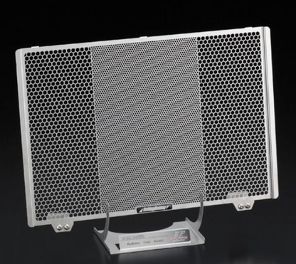 Metallic honeycomb panel on a stand against a black background