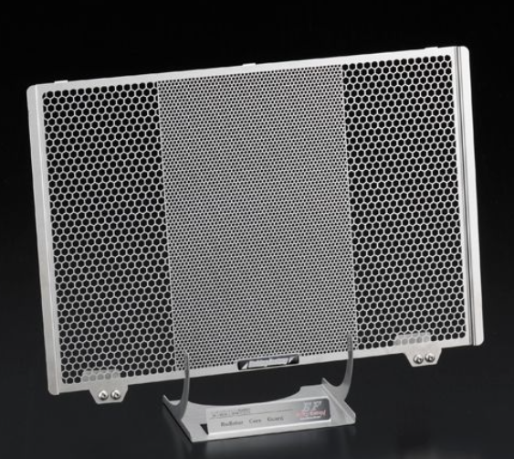 Metallic honeycomb panel on a stand against a black background