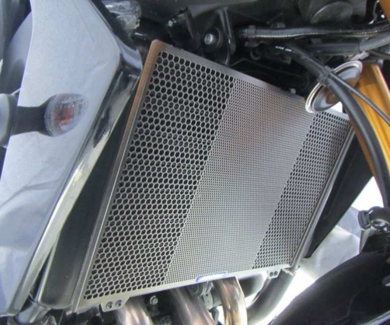 Motorcycle radiator guard with perforated design on a motorcycle