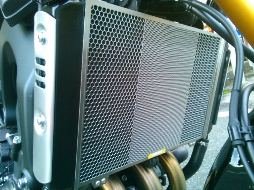 Motorcycle radiator with honeycomb design on a blurred background