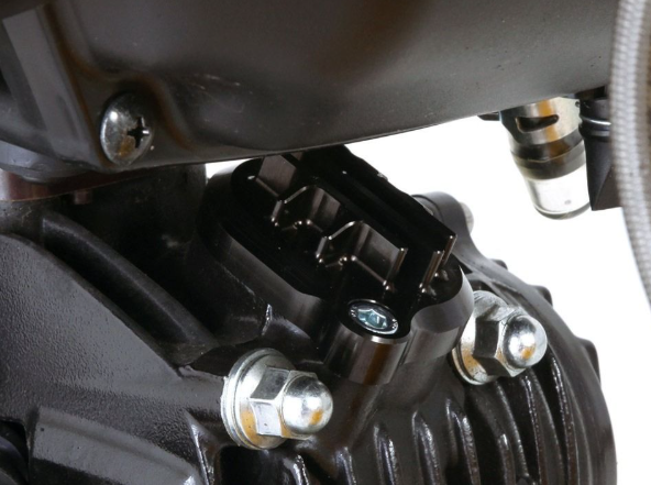 Close-up of a motorcycle engine with visible bolts and components.