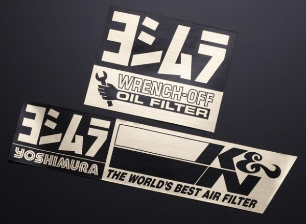 Three automotive-themed stickers on a black background