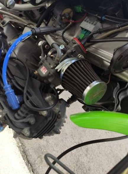 Close-up of a motorcycle engine with visible branding on a blurred background