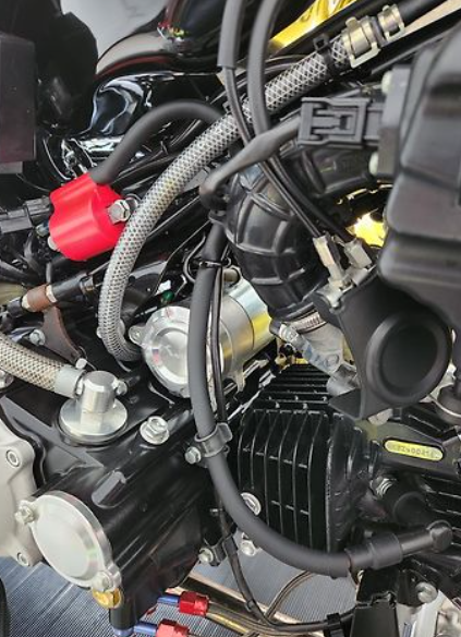 Close-up of a motorcycle engine with visible components and wiring.