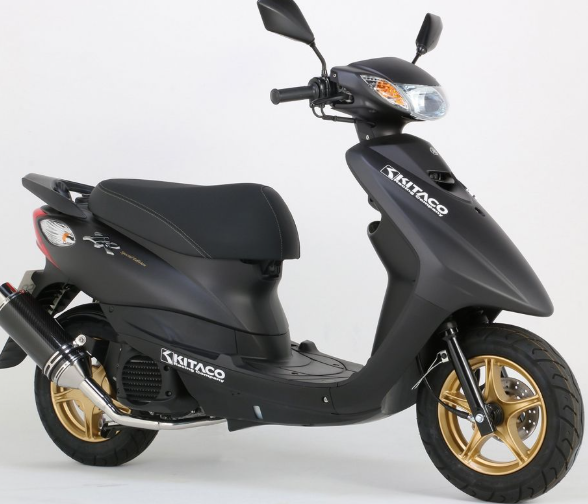 Black scooter with gold wheels on a white background