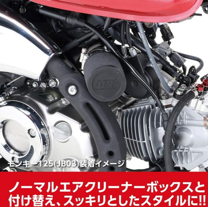 Close-up of a motorcycle engine with visible branding on a white background