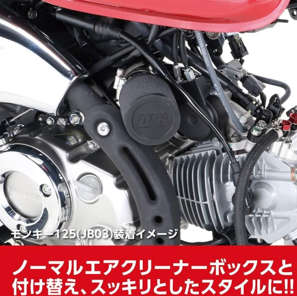 Close-up of a motorcycle engine with visible branding on a white background