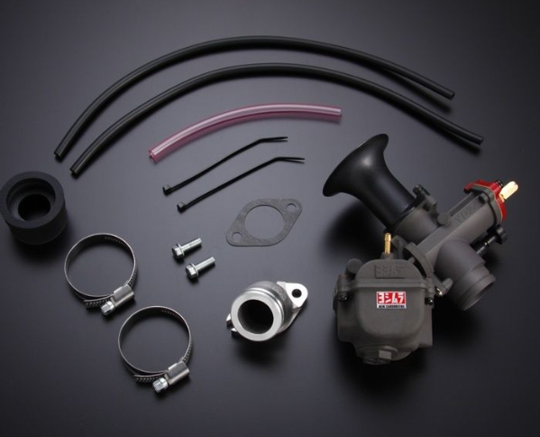 Automotive parts including a carburetor, hoses, and clamps on a dark background