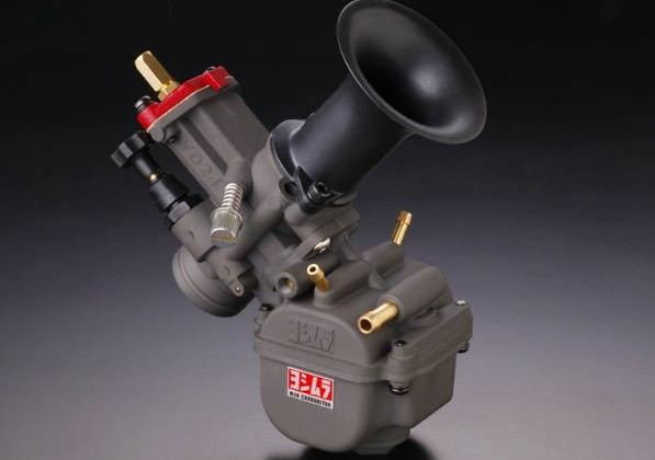 Carburetor with visible brand logo on a dark background