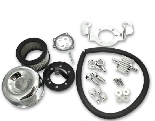 Collection of automotive parts including a pulley, belt, and various metal components on a white background.