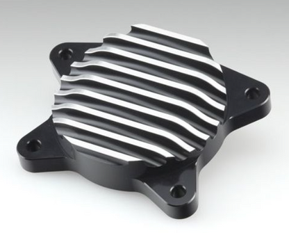 Metallic engine cover with ribbed design on a gray background