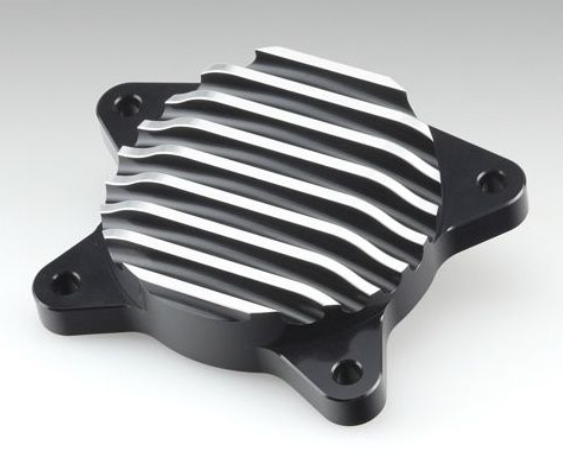 Metallic engine cover with ribbed design on a gray background