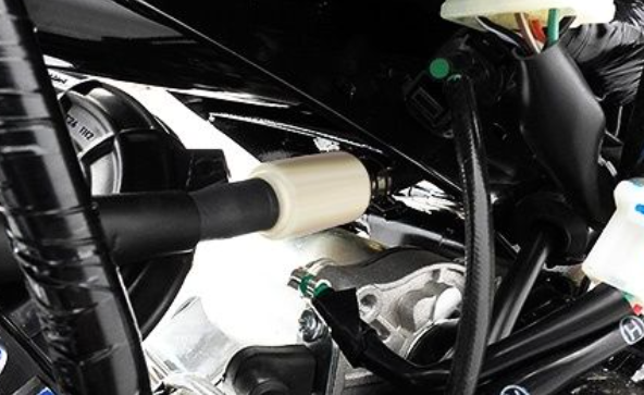 Close-up of a car's engine compartment with various components.