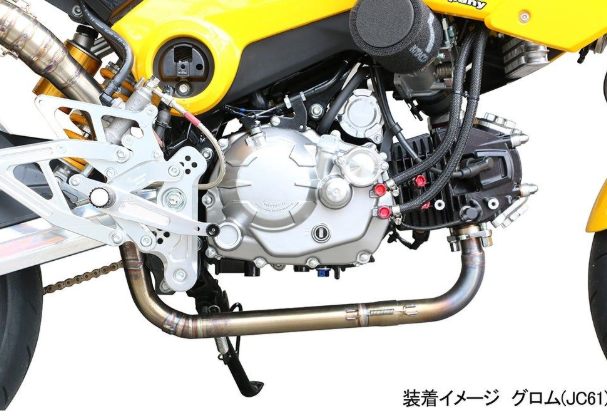 Close-up of a motorcycle engine with visible branding on a white background