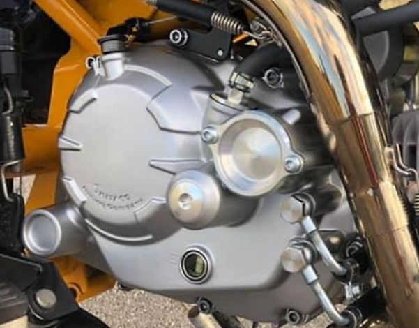 Close-up of a motorcycle engine with visible branding
