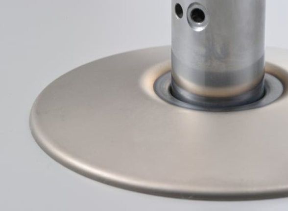 Metallic disc brake rotor on a gray background