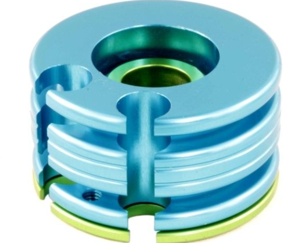 Metallic blue and green mechanical component on a white background