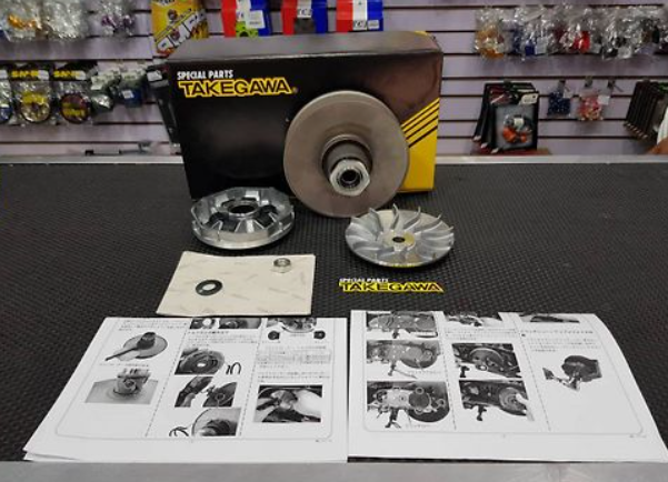 Takegawa grinding wheel and accessories on a workbench with manuals.