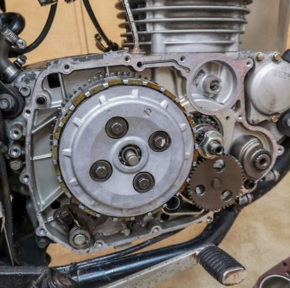 Close-up of a motorcycle engine with gears and mechanical components.