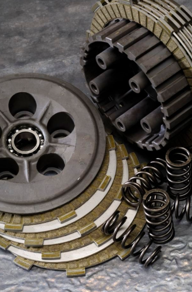 Clutch plates, springs, and pressure plate on a metallic surface