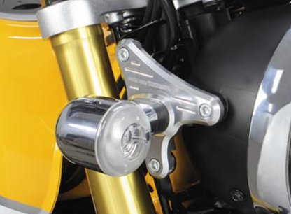 Close-up of a motorcycle's suspension system with gold and black components.