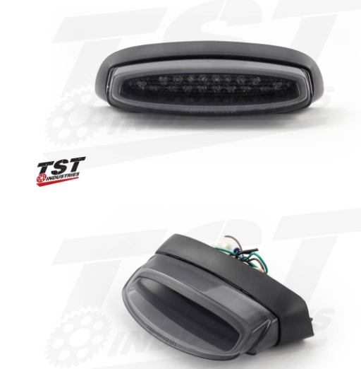 Two car lights on a white background with TST Industries logo.
