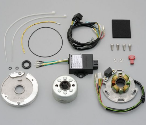 Collection of motorcycle parts including wiring harnesses, connectors, and metal components on a gray background.