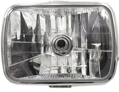 Car headlight with clear lens and metallic frame on a white background